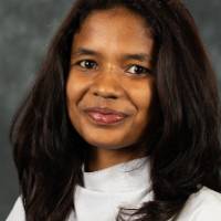 Woman posing for headshot, smiling